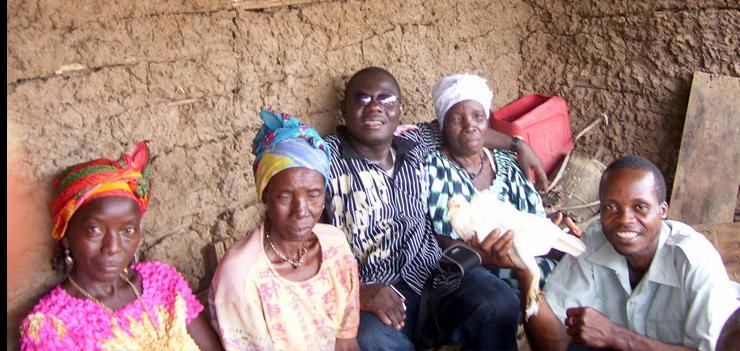 PFL Director, Reverend Kollie (left) reunites former detainee (far right) with his family