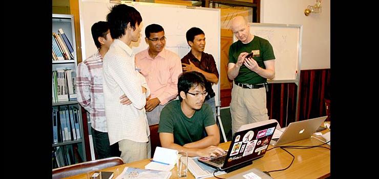 Cambodian Eng Vannak codes as Mozilla representative speaks with localization team.